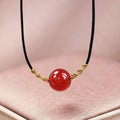 Hand-woven red agate bracelet and necklace set showing bean bead elements