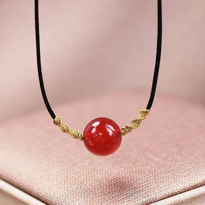 Hand-woven red agate bracelet and necklace set showing bean bead elements