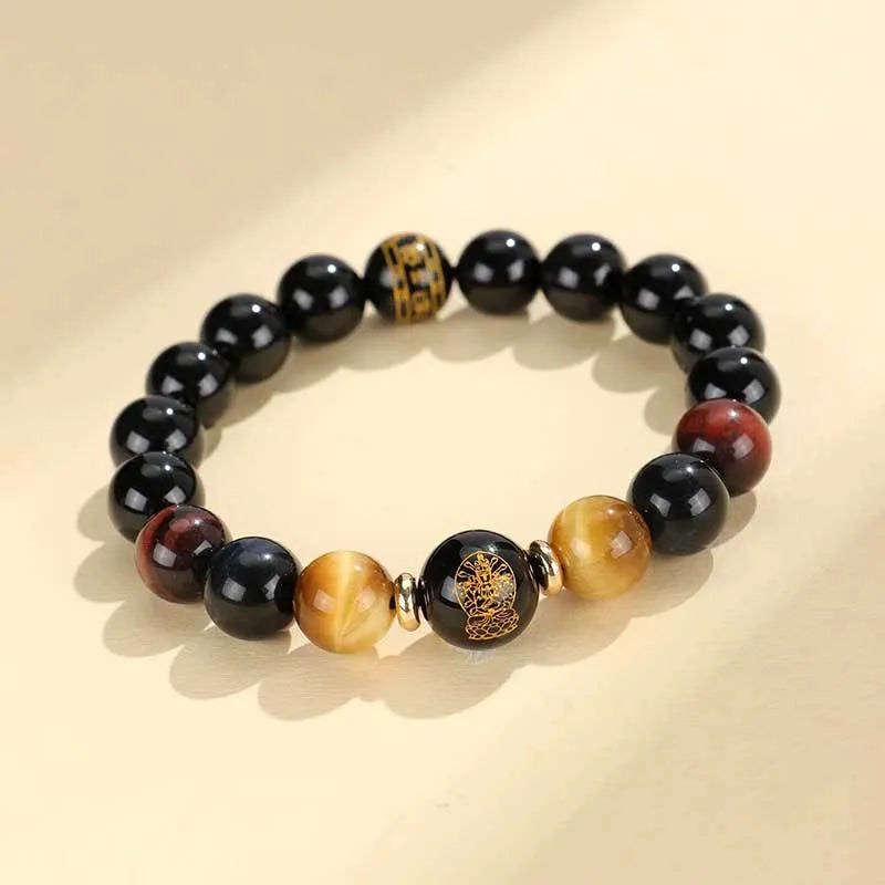 Handmade black agate beaded bracelet with gold, blue, and red tiger eye stones featuring Buddhist deity and zodiac animal motifs.