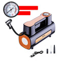 Black portable car tyre inflator with digital LCD screen and USB charging cable on a grey background