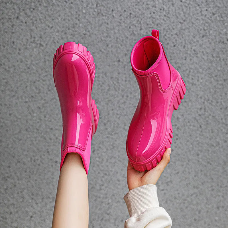 Women's creamy white PVC low tube rain boots with a flat heel on a white background.