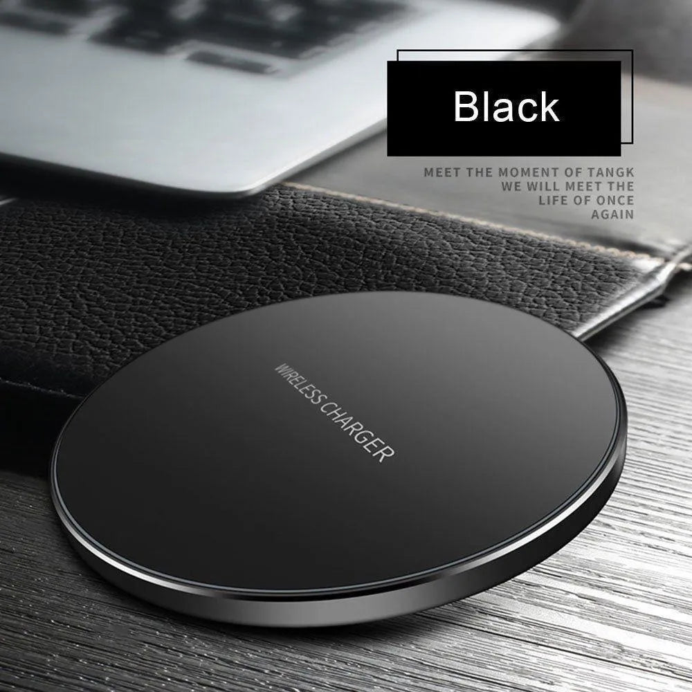 Black ultra-thin square wireless fast charger with USB cable on a desk