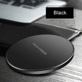 Black ultra-thin square wireless fast charger with USB cable on a desk