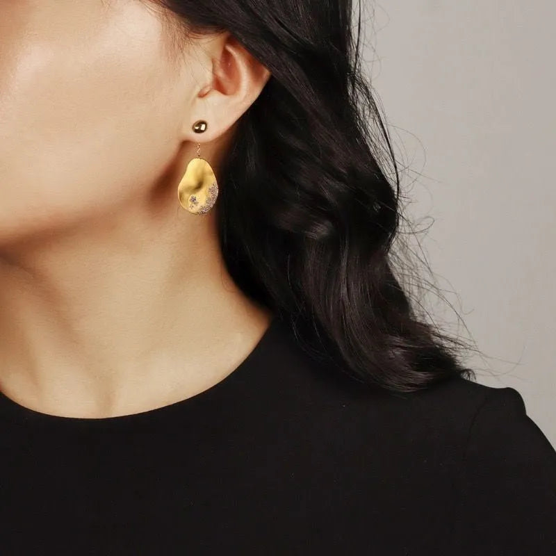 Asymmetric floral earrings with zircon crystals in gold or silver colour options