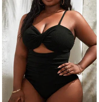 Black plus size one-piece swimsuit for women on a mannequin, showing sleeveless bikini style.