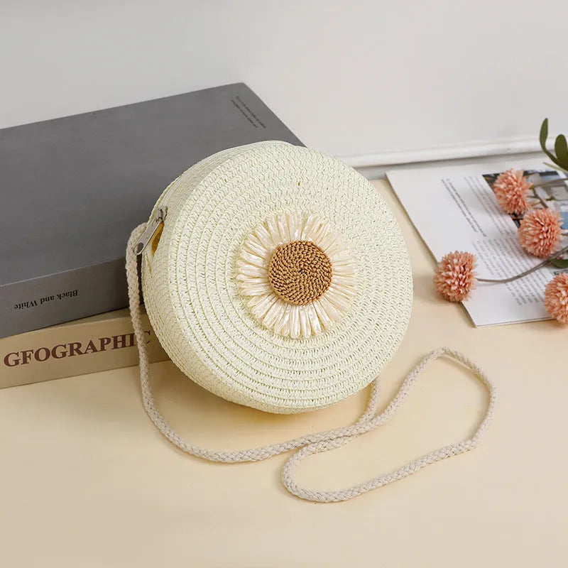 Round woven raffia crossbody bag with floral accents in 16cm diameter for mobile phones