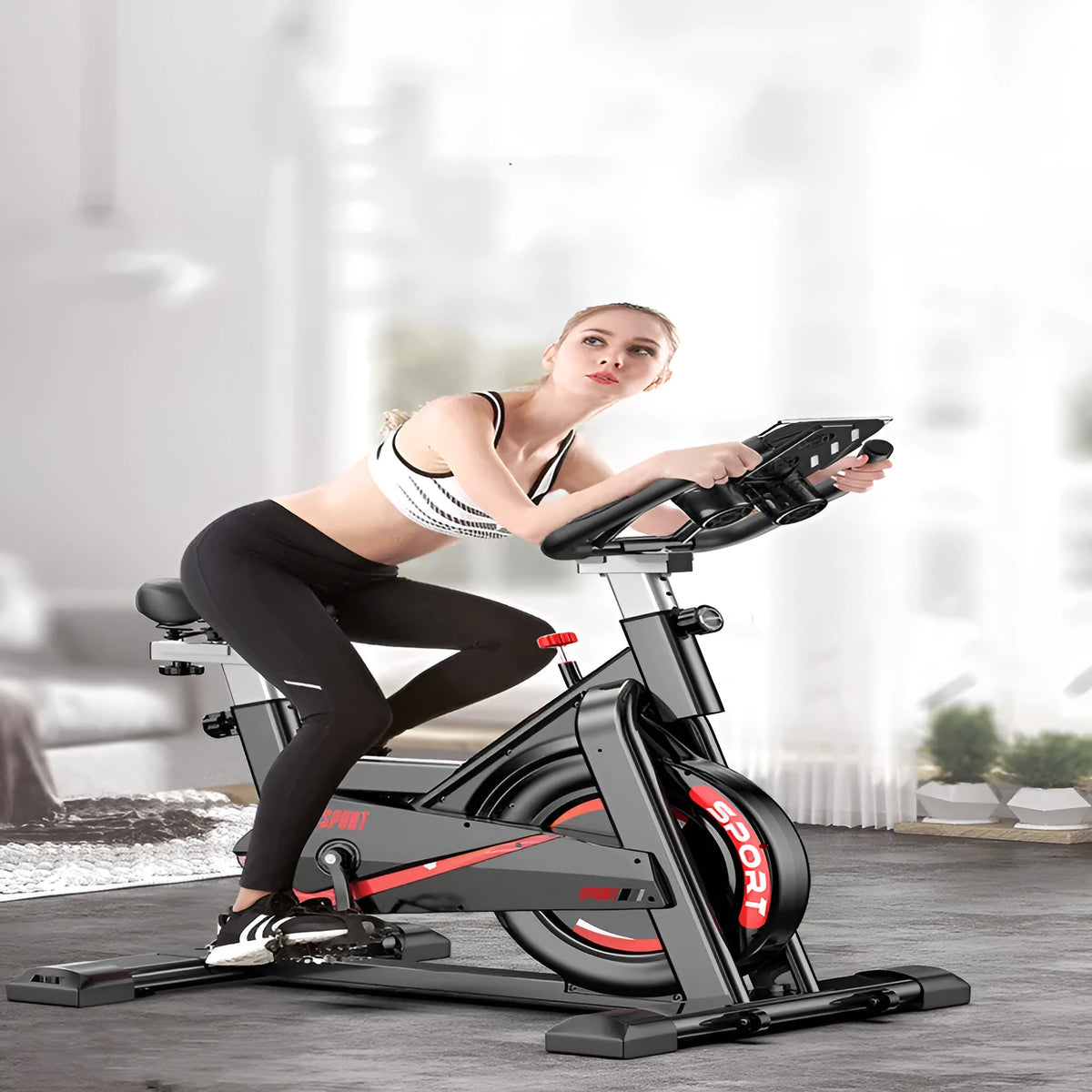 Black upright spinning bike with steel frame and console display for home cardio cycling