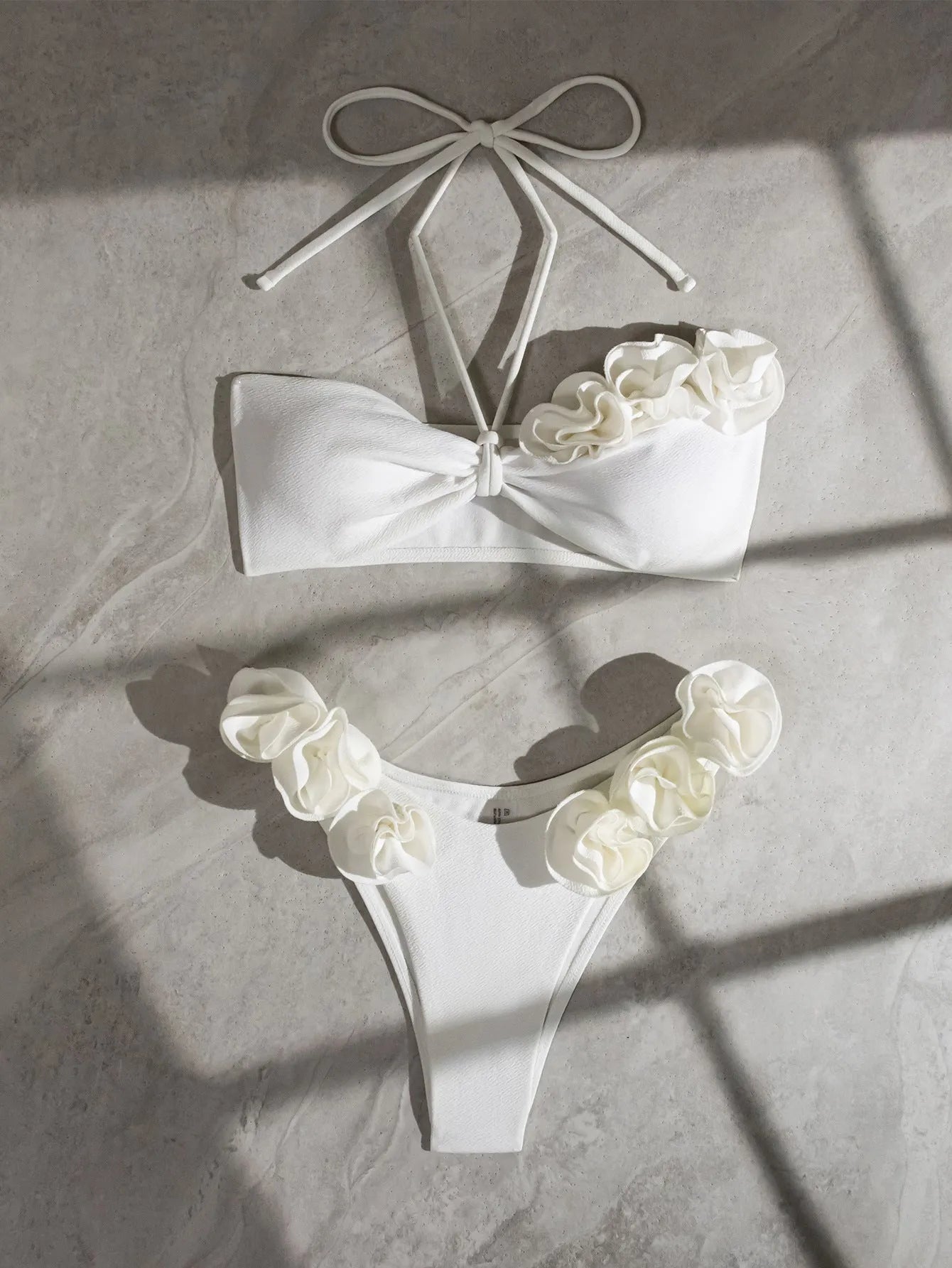 White halter neck lace-up swimsuit with three-dimensional floral pattern and split briefs style