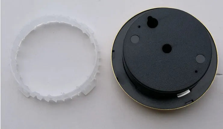 Analogue thermometer and hygrometer with silver aluminium dial and outer ring.