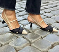 Women's apricot and black colour block stiletto sandals with pointed toe and buckle strap.