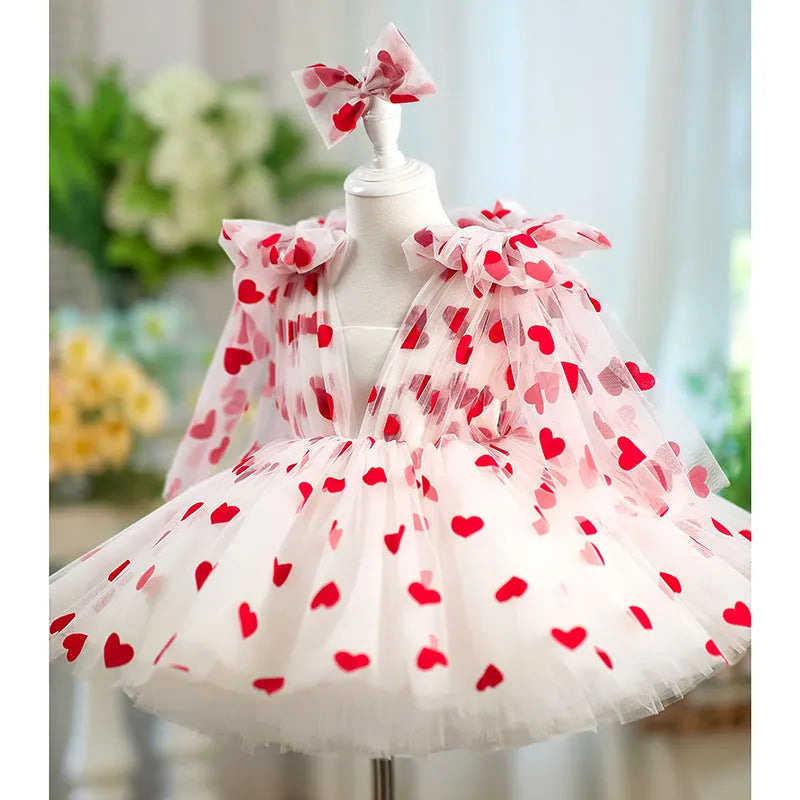 Children red love princess dress gown with heart print on light background, front view
