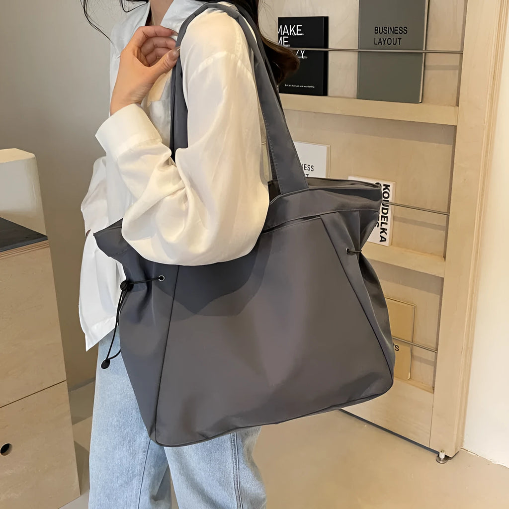 Soft Oxford cloth folding tote bag in five colour options showing shoulder carry design