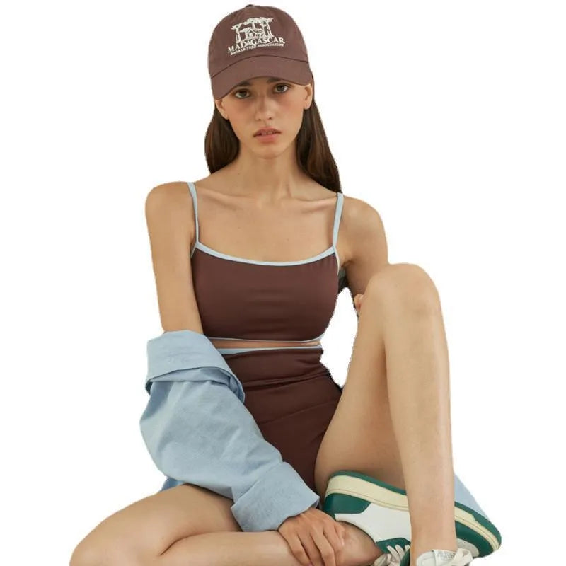 Brown women's one-piece triangle swimsuit on a hanger, showing nylon fabric texture.