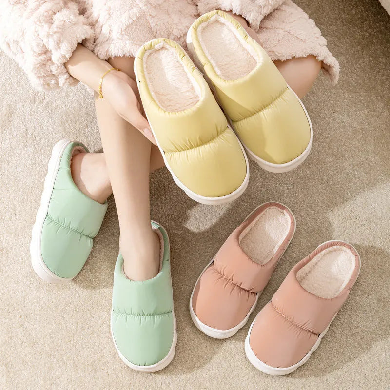 A pair of down cotton indoor slippers with a thick rubber sole and plush lining, shown in a choice of colours.