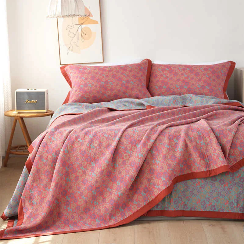 Three-piece cotton gauze bedding set with floral pattern showing blanket and two pillowcases