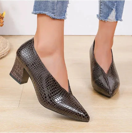 Women's black V-cut pointed toe Martin boots with embossed design and chunky heel