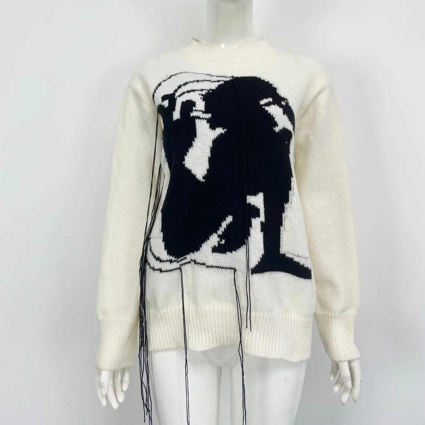 Grey women's loose alpaca wool sweater with tassel detailing and abstract pattern