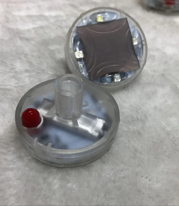 Colourful solar-powered LED valve cap light for car or bike wheel with installation screws.