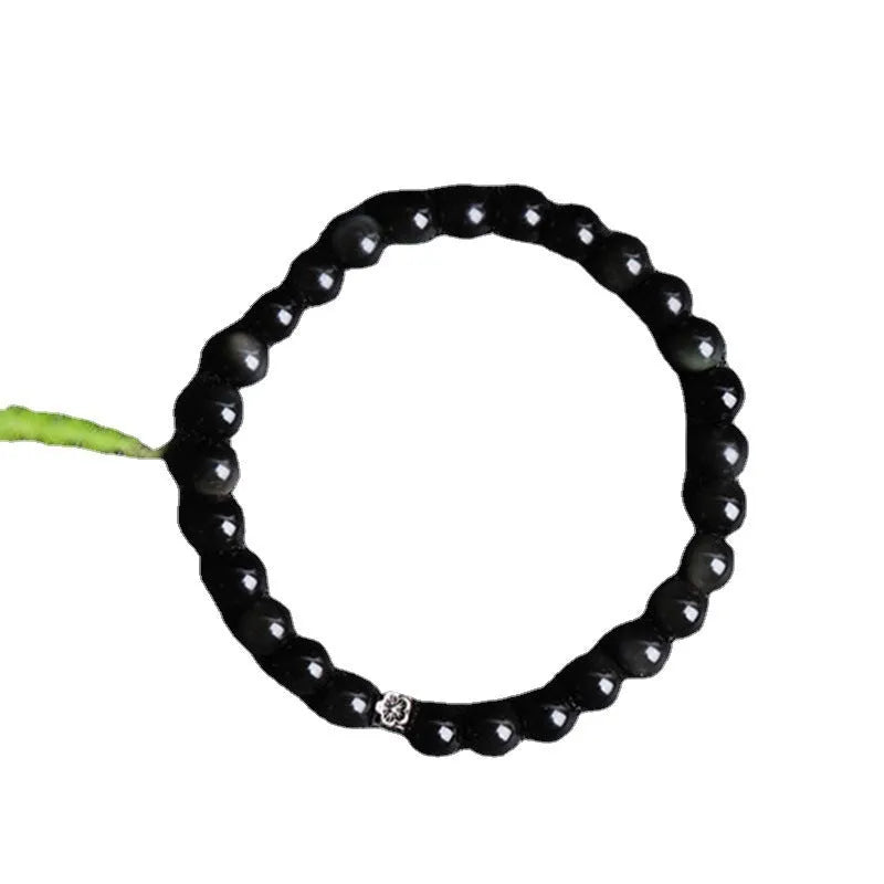 Natural obsidian beaded bracelet with S925 silver flower charms and dragon phoenix constellation design.