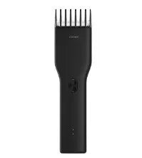 Black cordless men's hair clipper with ceramic blades and adjustable length comb