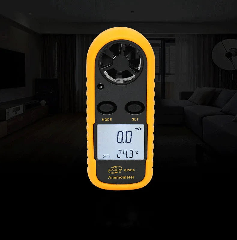 Orange digital portable anemometer wind speed measuring instrument showing compact size.