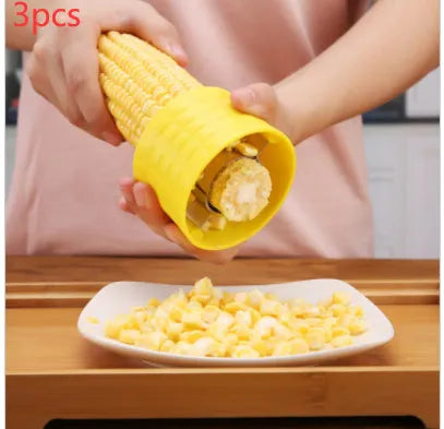 Yellow manual corn grinder thresher with corn-kernel-shaped PP body and stainless steel gear.