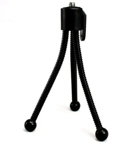 Small black iron mini tripod with ball head, shown folded to 110mm next to a smartphone.