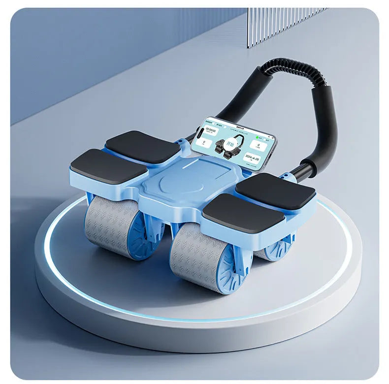 Black four-wheel abdominal roller with automatic rebound mechanism on a wooden floor