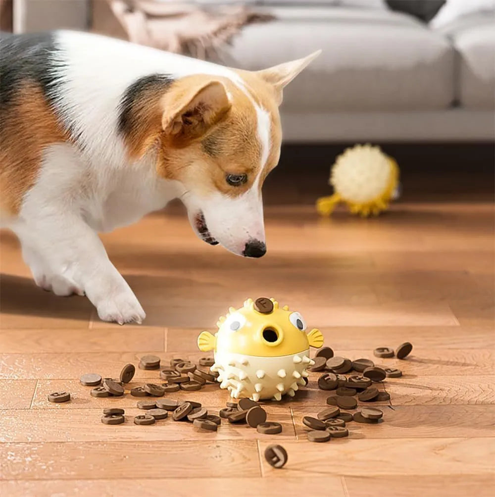 Green fish-shaped interactive dog toy with treat hole and textured surface.