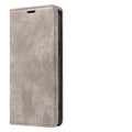 Magnetic flip phone case for iPhone shown closed, displaying the leather front cover and magnetic closure in grey.