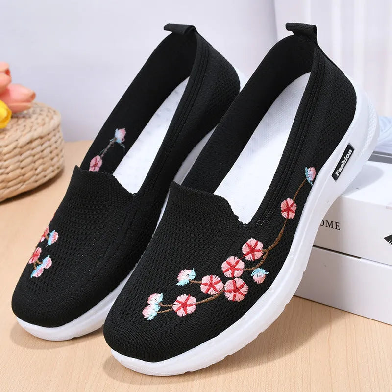 Women's wine red embroidered low heel pumps with round toe and anti-slip sole.