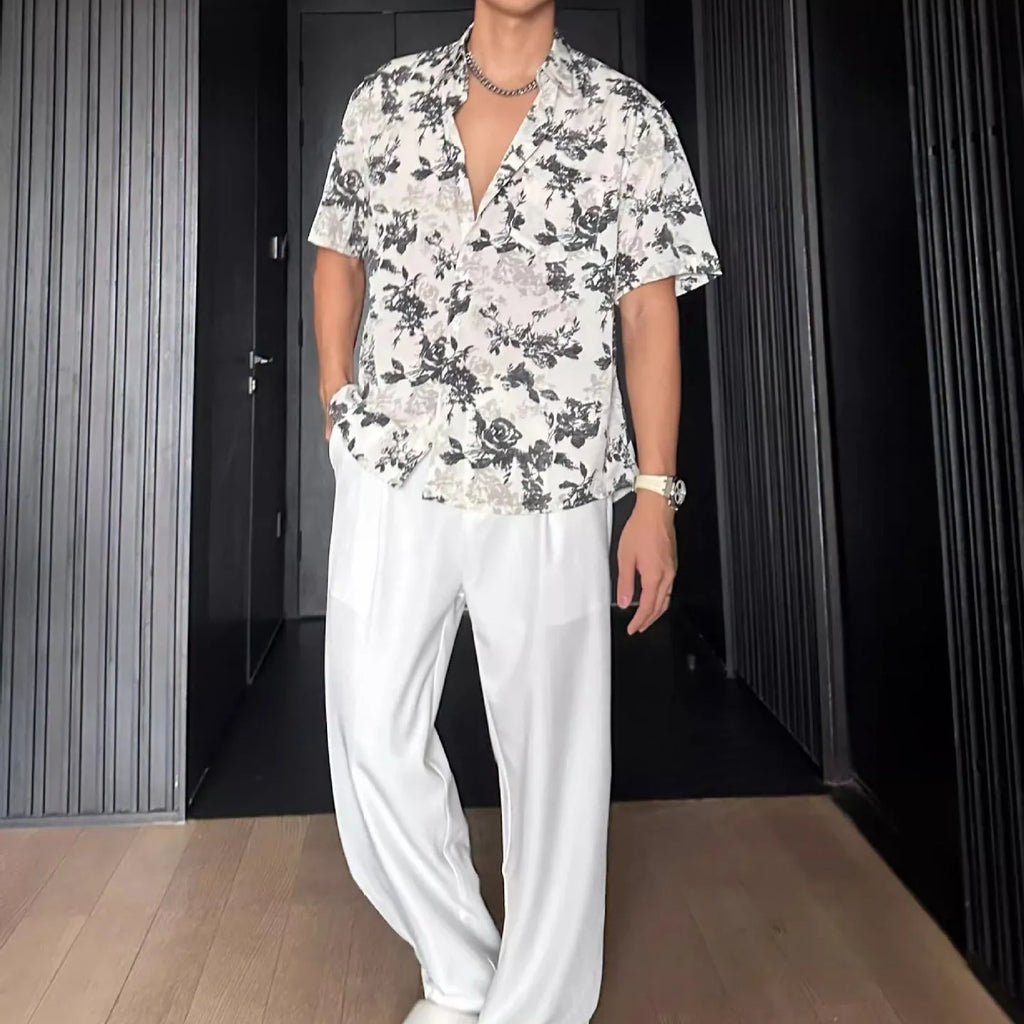 A loose-fitting, short sleeve casual shirt with a floral print, shown in a cardigan style.