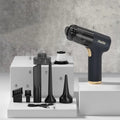 Black wireless handheld vacuum cleaner with attachments including nozzles and brushes on a white background.