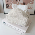 Cotton floral tissue box cover in beige, blue, and brown colour options on a table.