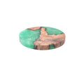 Set of solid colour resin coasters in black and green, showing round and square shapes on a wooden table.