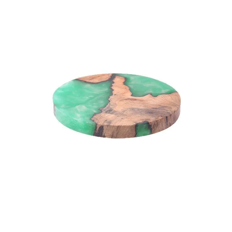 Set of solid colour resin coasters in black and green, showing round and square shapes on a wooden table.