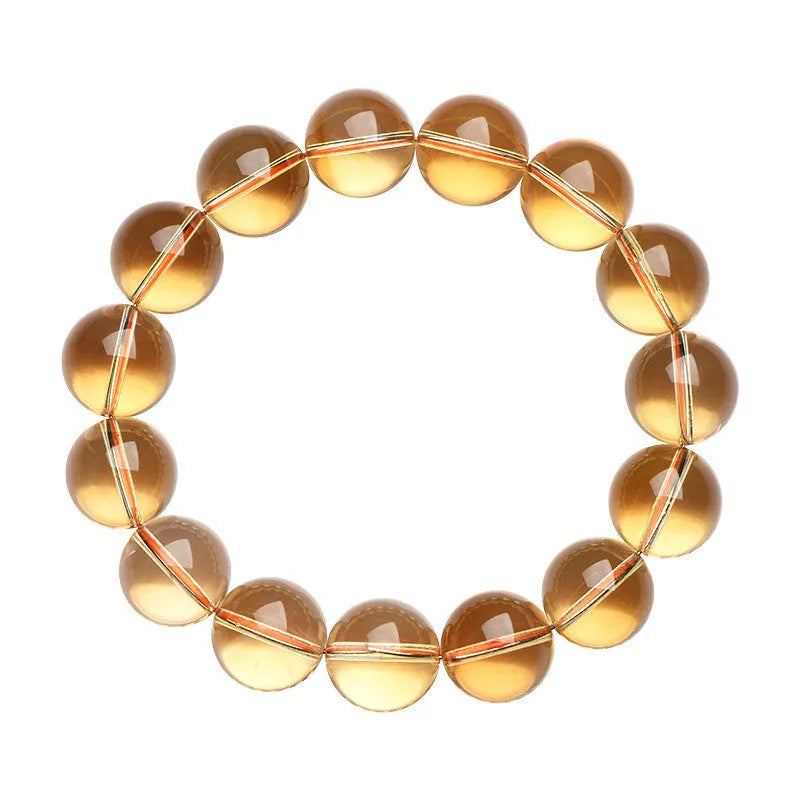 Original design natural citrine scattered bead bracelet on a wrist, showing polished stones in a golden hue.