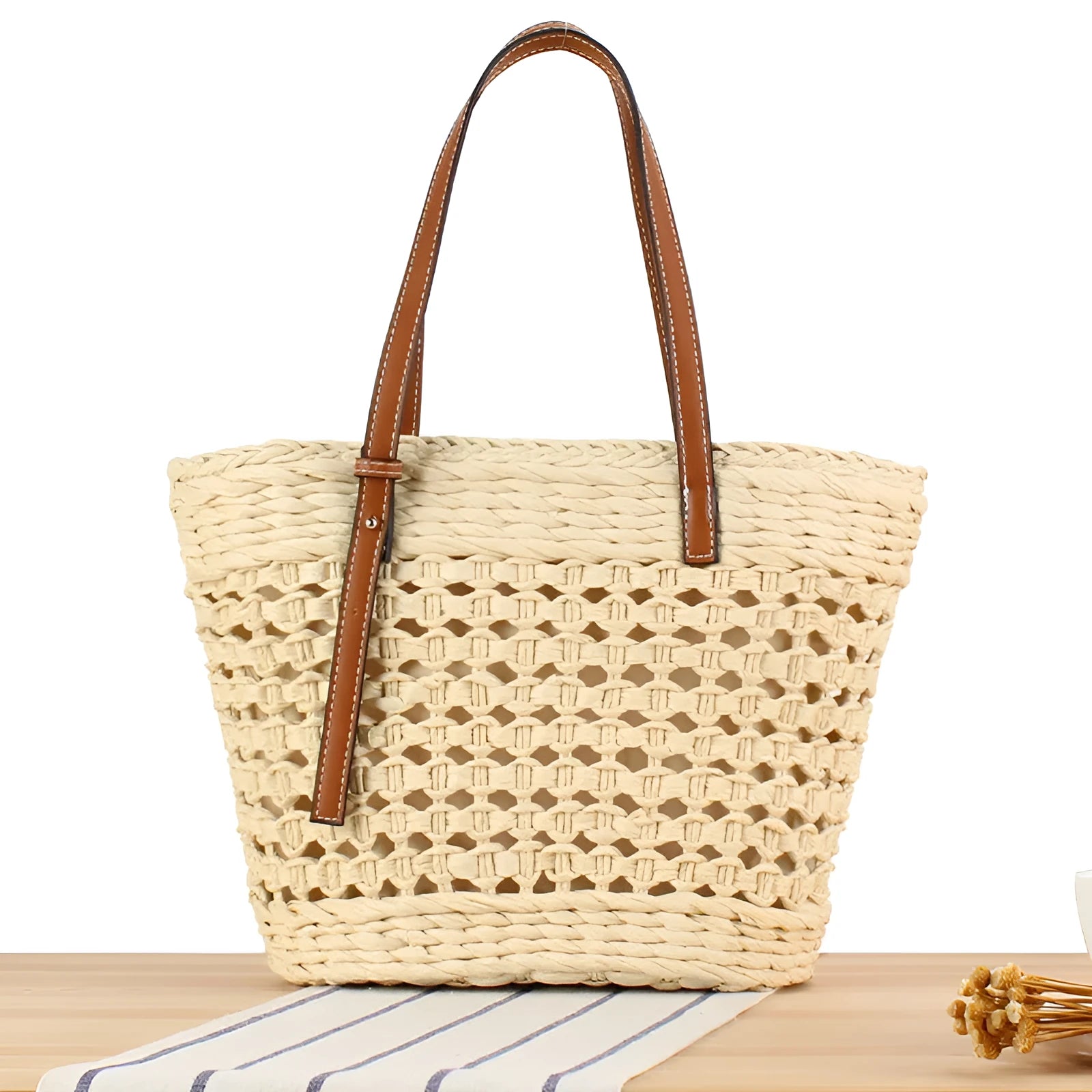 Beige paper string woven large capacity shoulder bag showing horizontal square shape and adjustable strap.