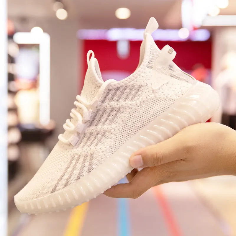 Men's white breathable flying fabric sports shoes with round toe and flat platform heel on a solid background.