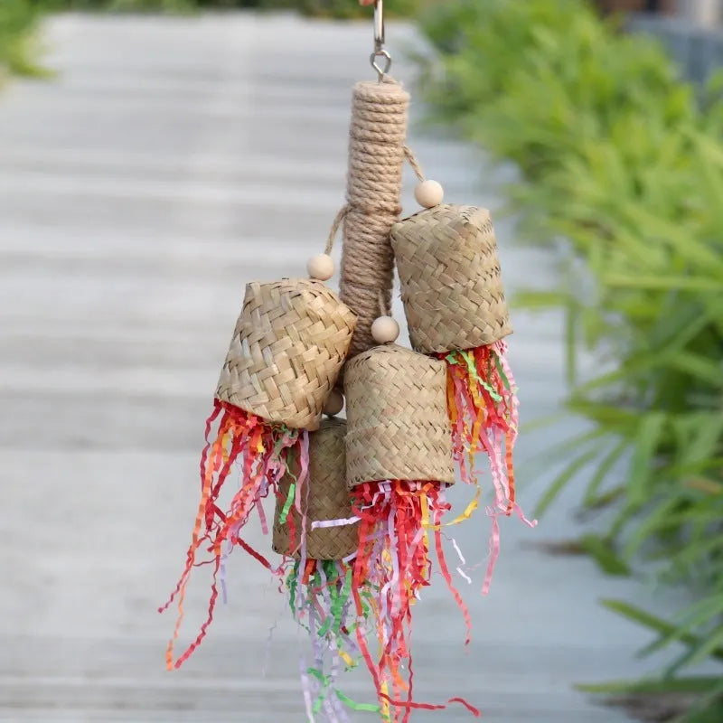 Wooden parrot chewing toy with colourful shredded paper decorations and sisal rope attachments