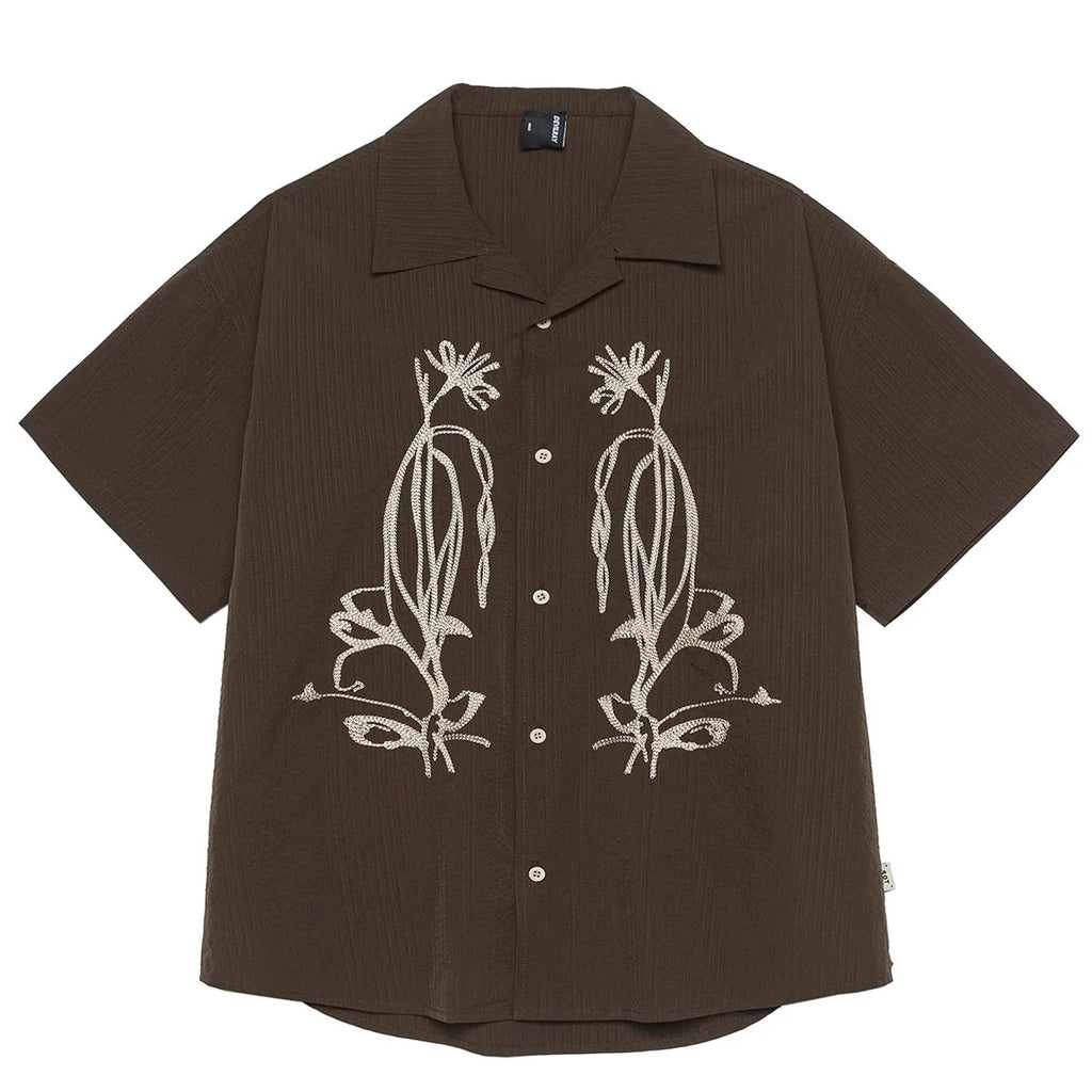 Brown striped men's short sleeve outdoor shirt with Cuban collar on a mannequin.