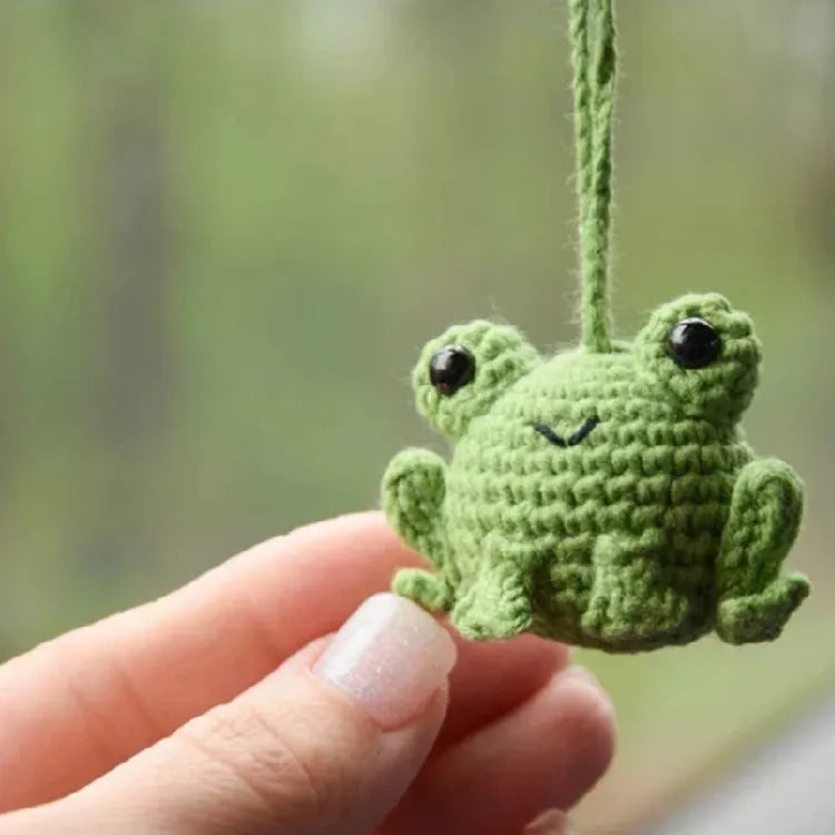 Handmade woven green plush frog pendant for car interior decoration.