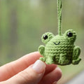Handmade woven green plush frog pendant for car interior decoration.