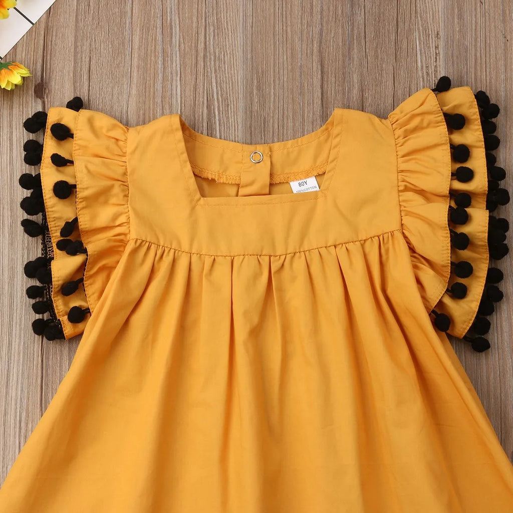 Orange sleeveless dress for toddler girl with shirring detail on front and elasticated back.