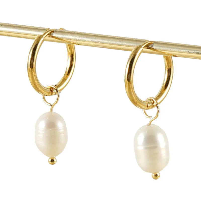 A pair of gold-coloured geometric earrings with a pearl detail, made from stainless steel.