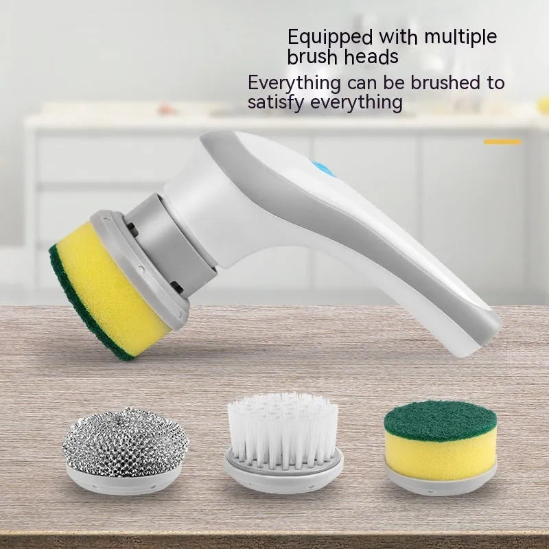 White cordless electric cleaning brush with multiple brush heads on a cleaning surface