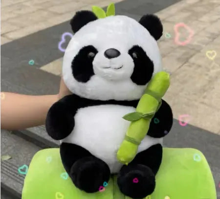 Black and white panda plush doll holding a simulated bamboo tube, a soft decorative cushion.