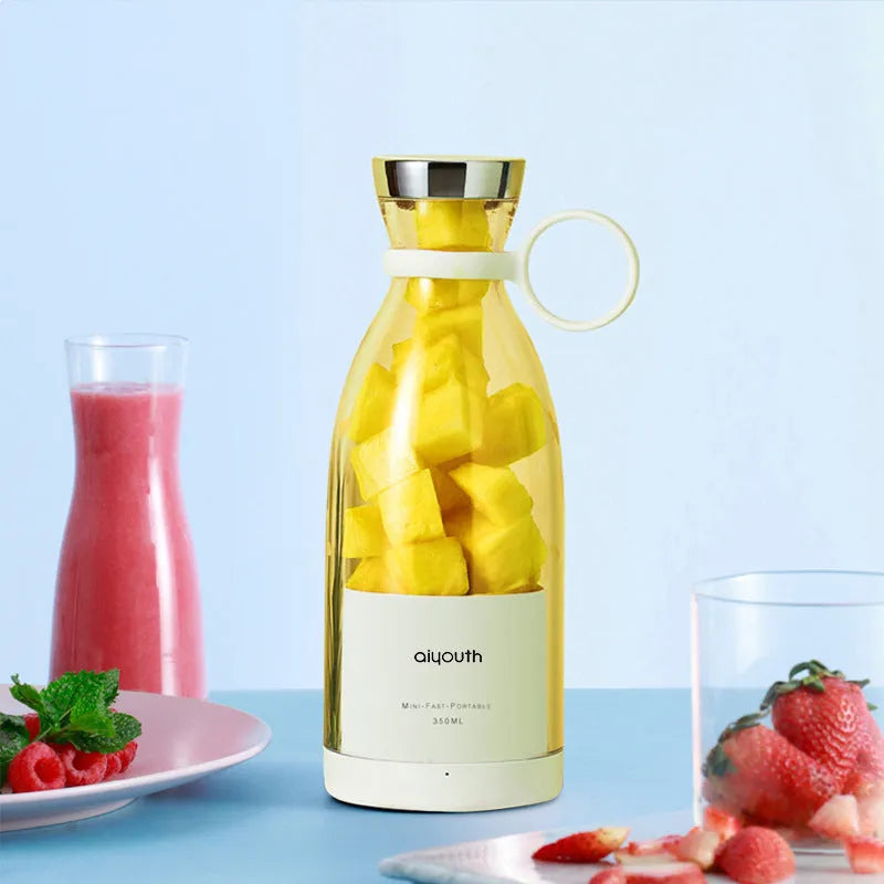 Handheld portable USB mini juicer in pink with four cutter head system for fresh juice extraction