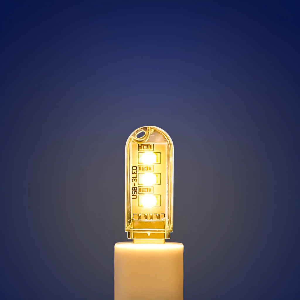 Small round white USB LED night light for nursery or bedroom on a dark surface.