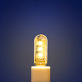 Small round white USB LED night light for nursery or bedroom on a dark surface.
